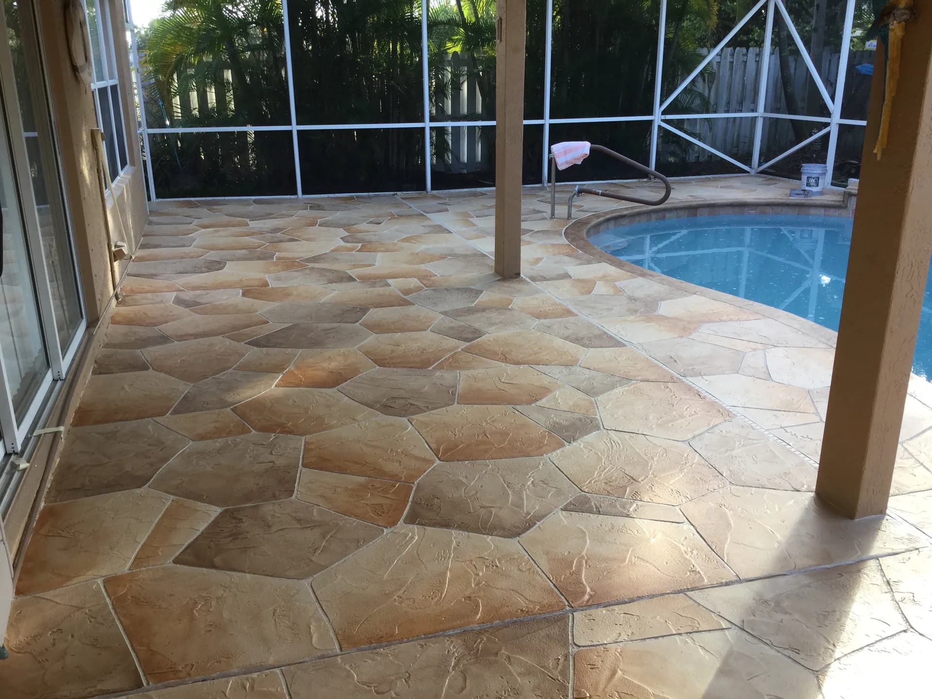 Stamped concrete patio with earth-tone colors in South Florida backyard