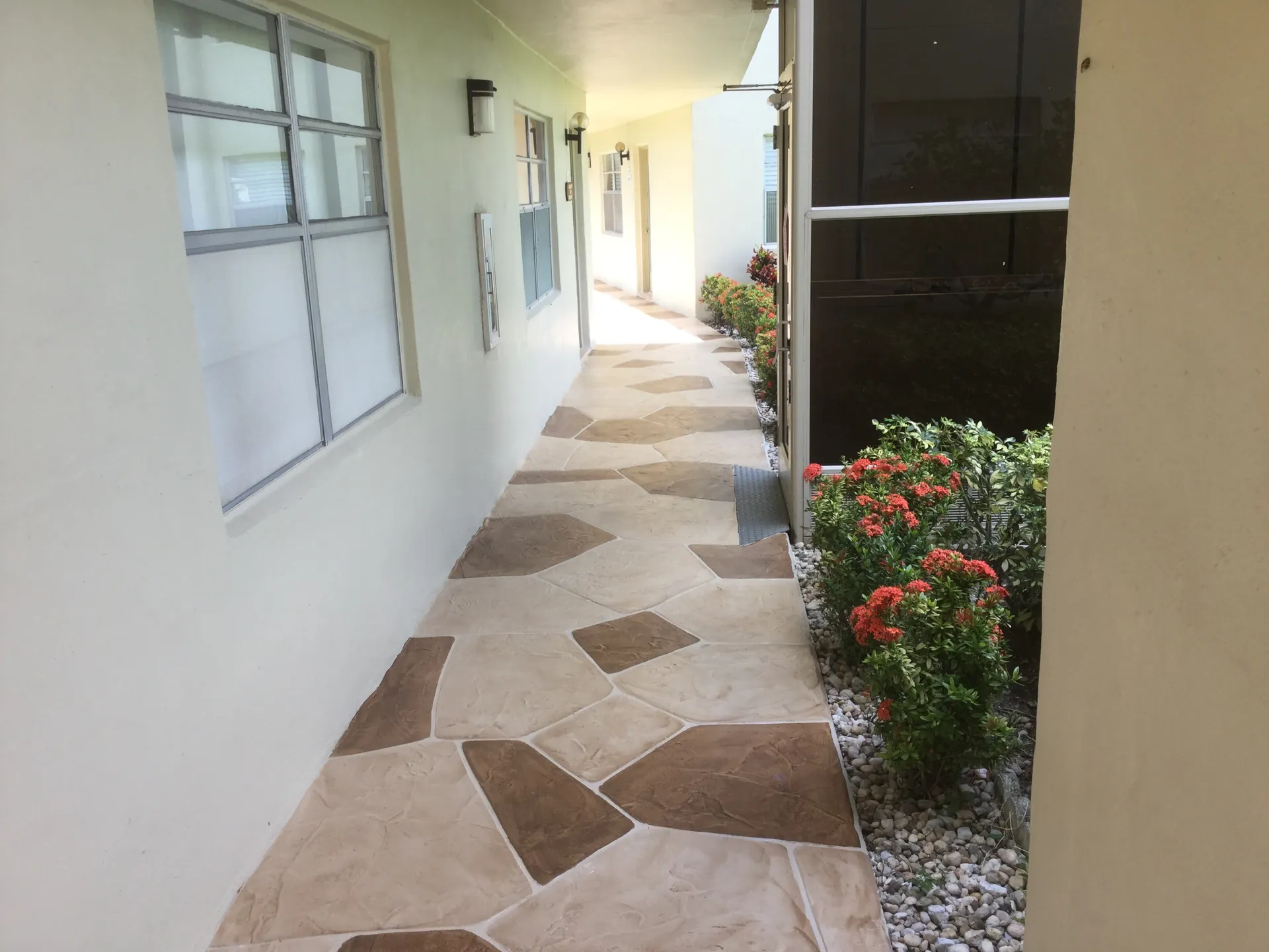 Concrete patio with decorative overlay applied to existing slab in South Florida