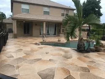 Resurfaced pool deck with storm-resistant finish at a Palm Beach County home