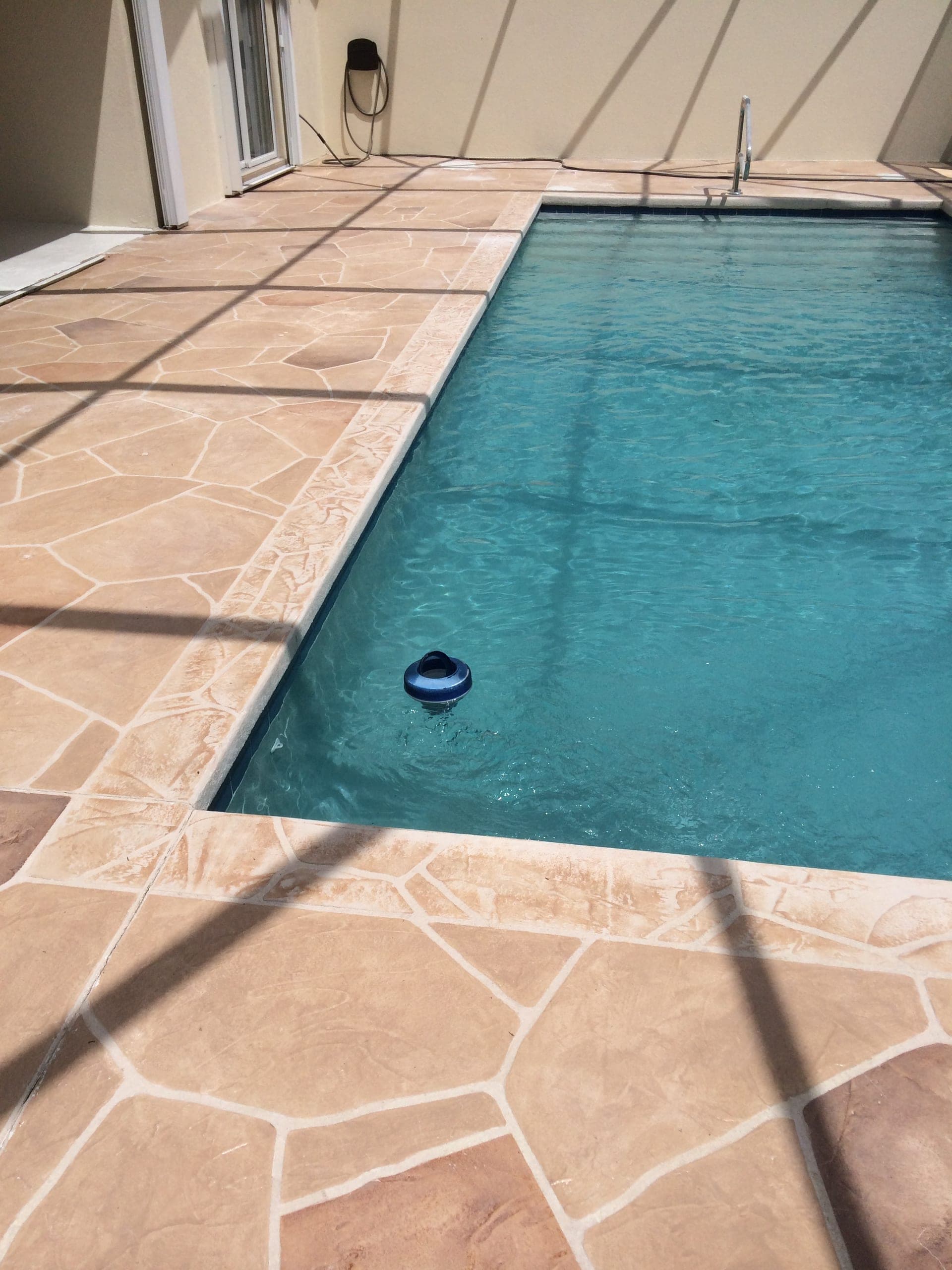Tan flagstone rectangular pool deck