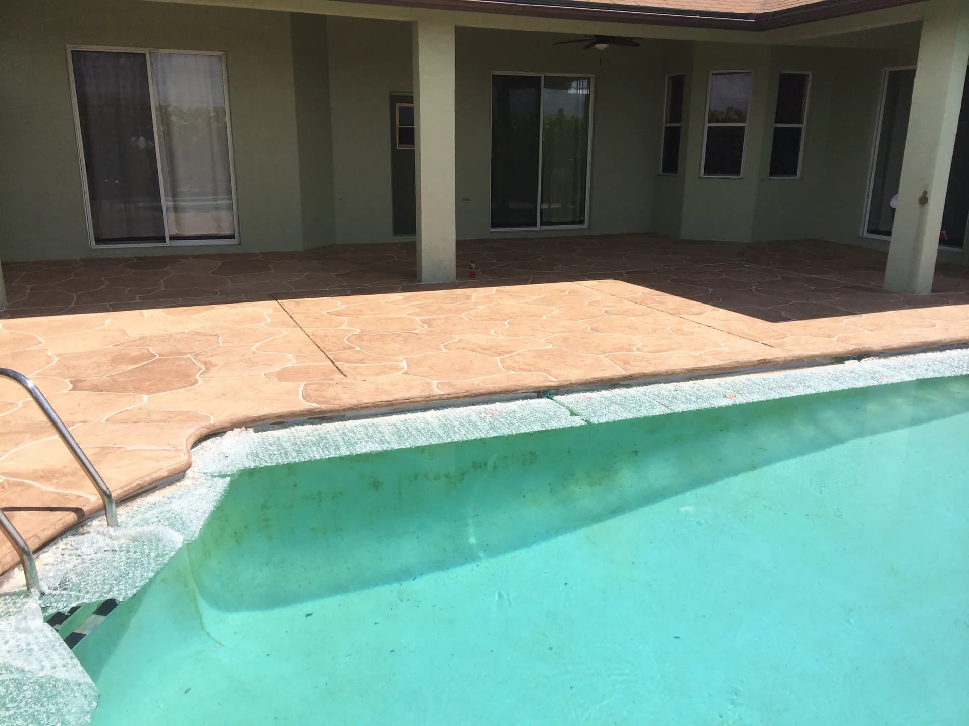 Pool deck resurfacing project near Jupiter, FL showing before and after