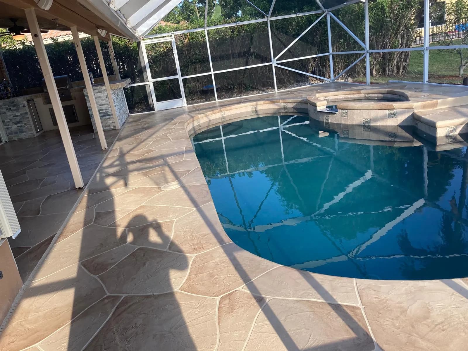 Completed pool deck resurfacing with flagstone pattern overlay