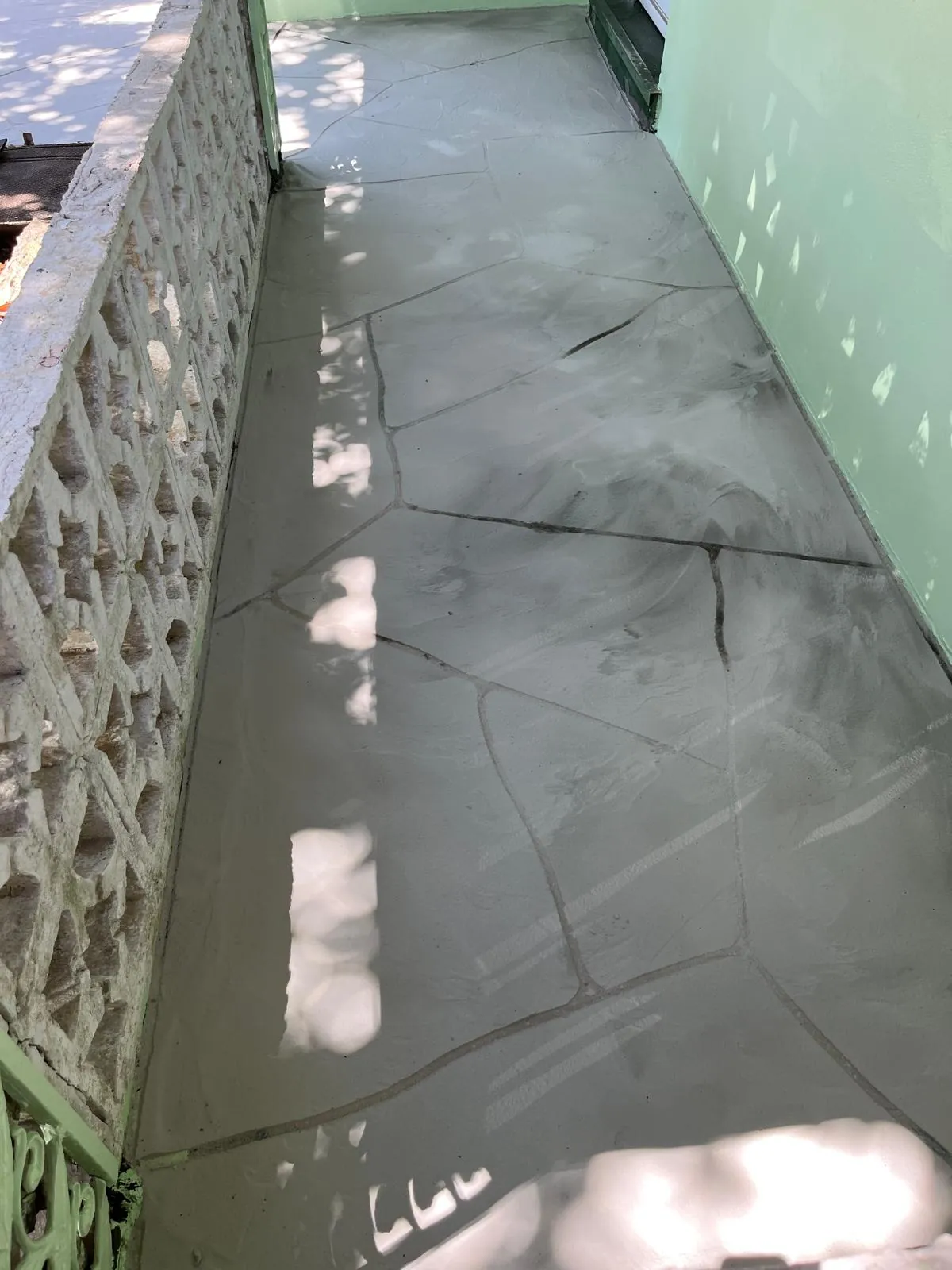Settled concrete walkway being evaluated for leveling in Palm Beach County