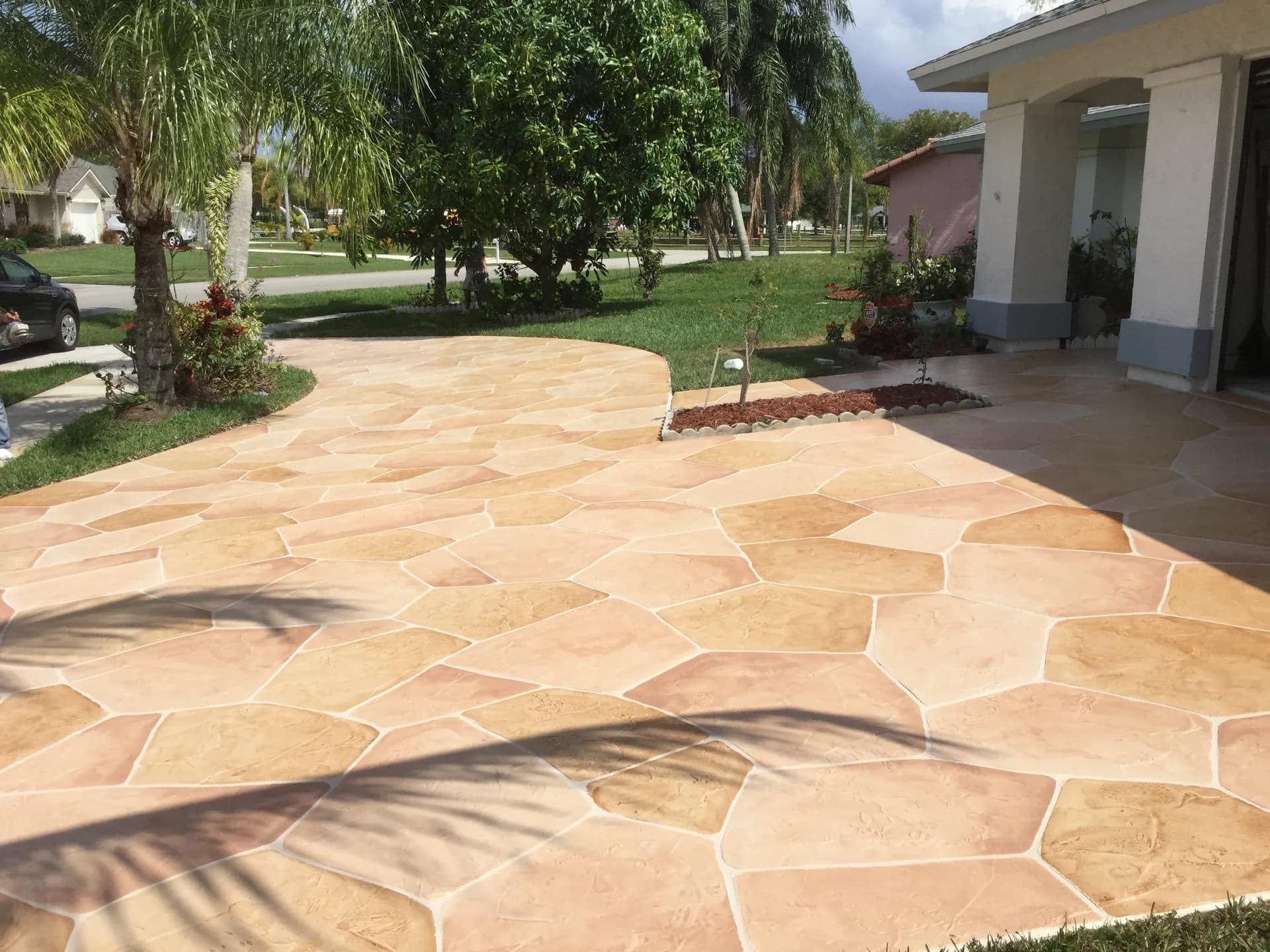 Decorative concrete driveway with stone pattern overlay in Palm Beach County